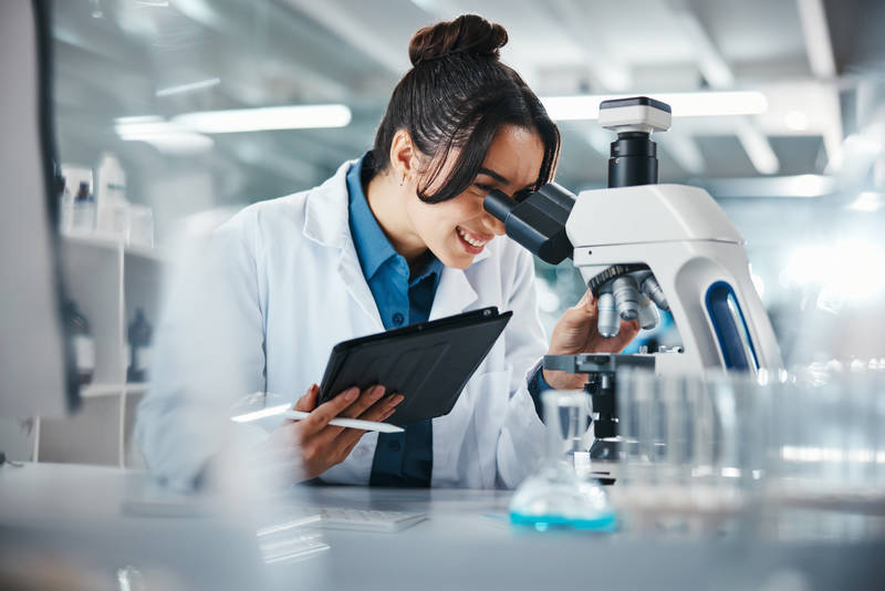 smiling-young-woman-scientist-working-with-microsc-2026-03-25-02-47-23-utc – compress